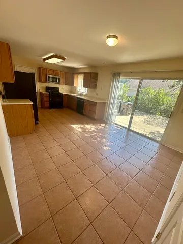 a view of living room with furniture and a floor to ceiling window