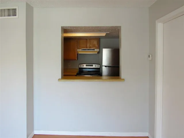 a kitchen with a sink stove and refrigerator