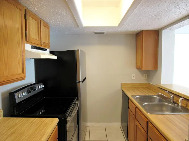 a view of an empty room and a bathroom