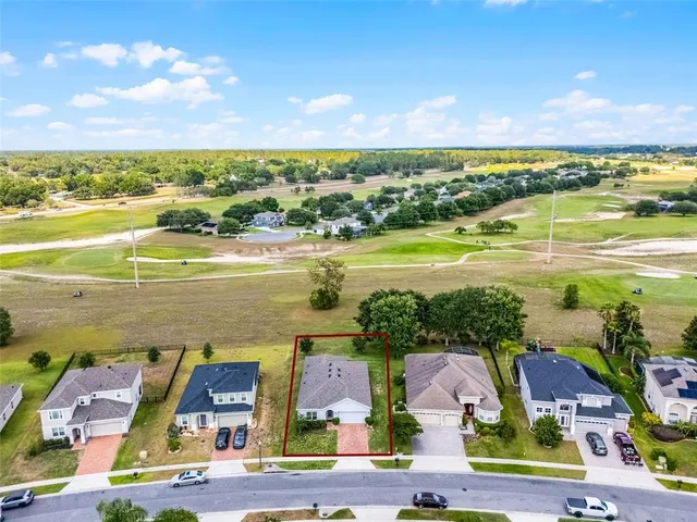 a view of house with garden and lake view