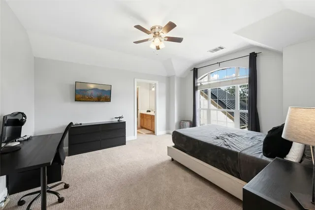 a bedroom with a large bed and a window