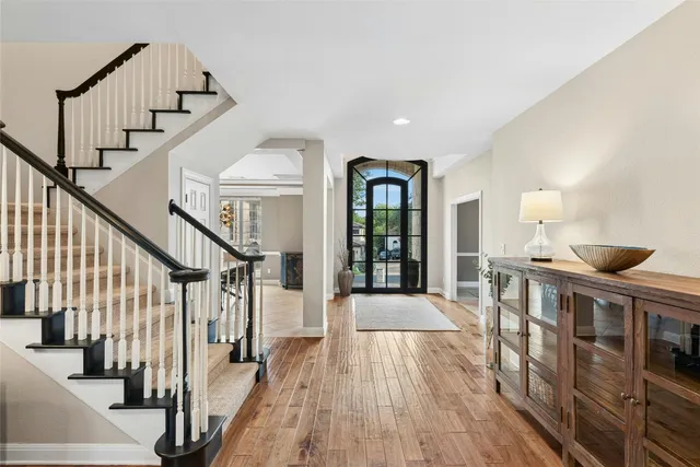 a view of entryway and hall with wooden floor