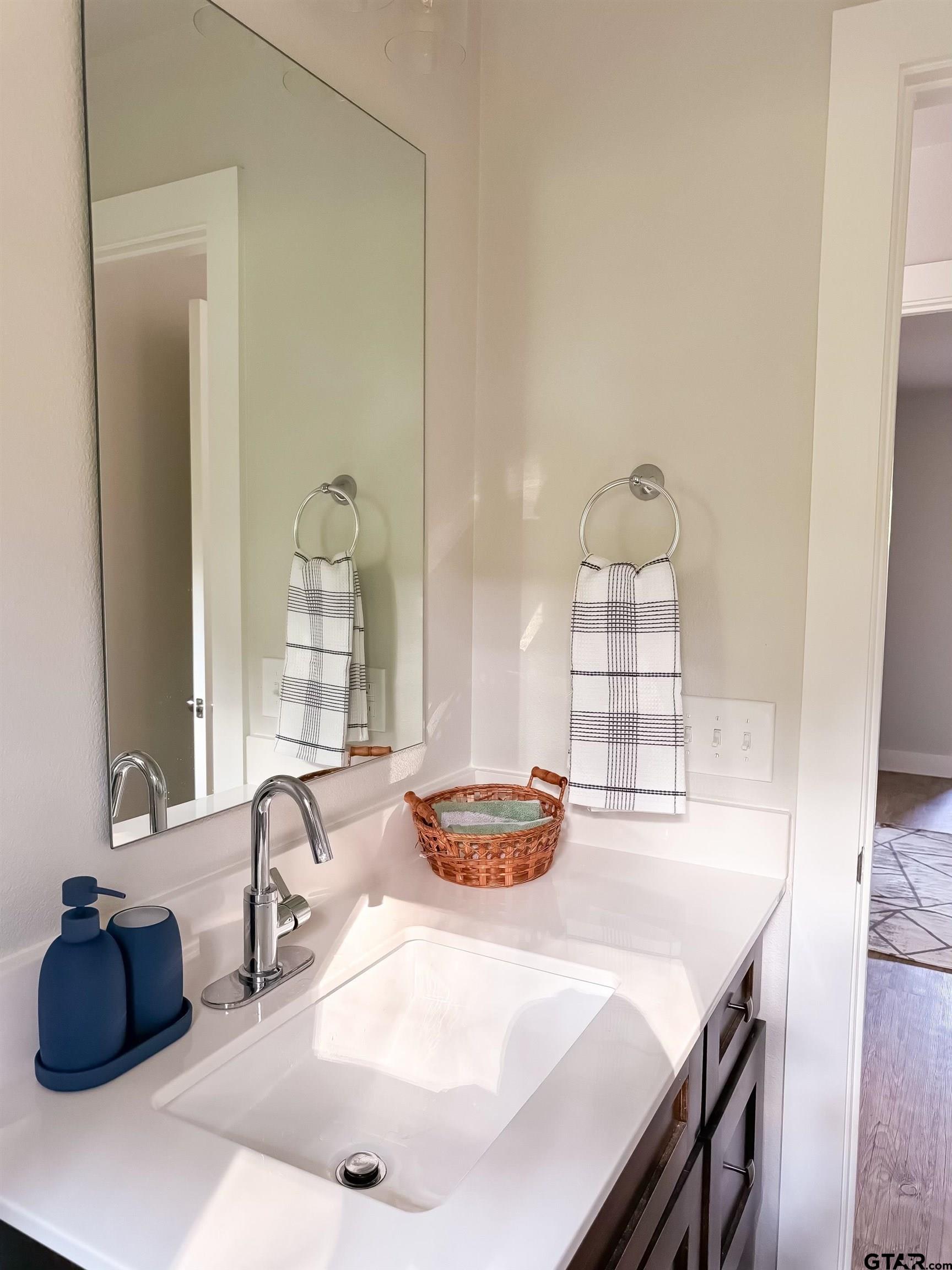 11722 Fm 16, Unit A Lindale, TX 75771 - Photo 14 of 17 a bathroom with a sink and a mirror
