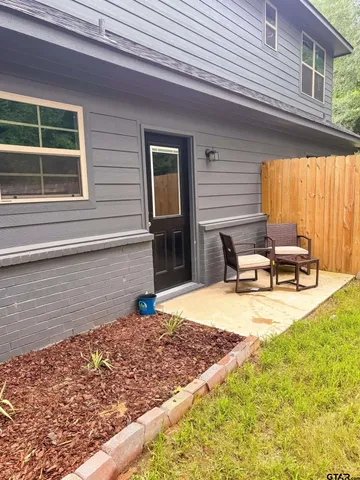 a view of a house with a swimming pool and a yard