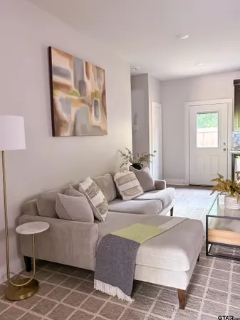 a kitchen with a dining table chairs and a sink