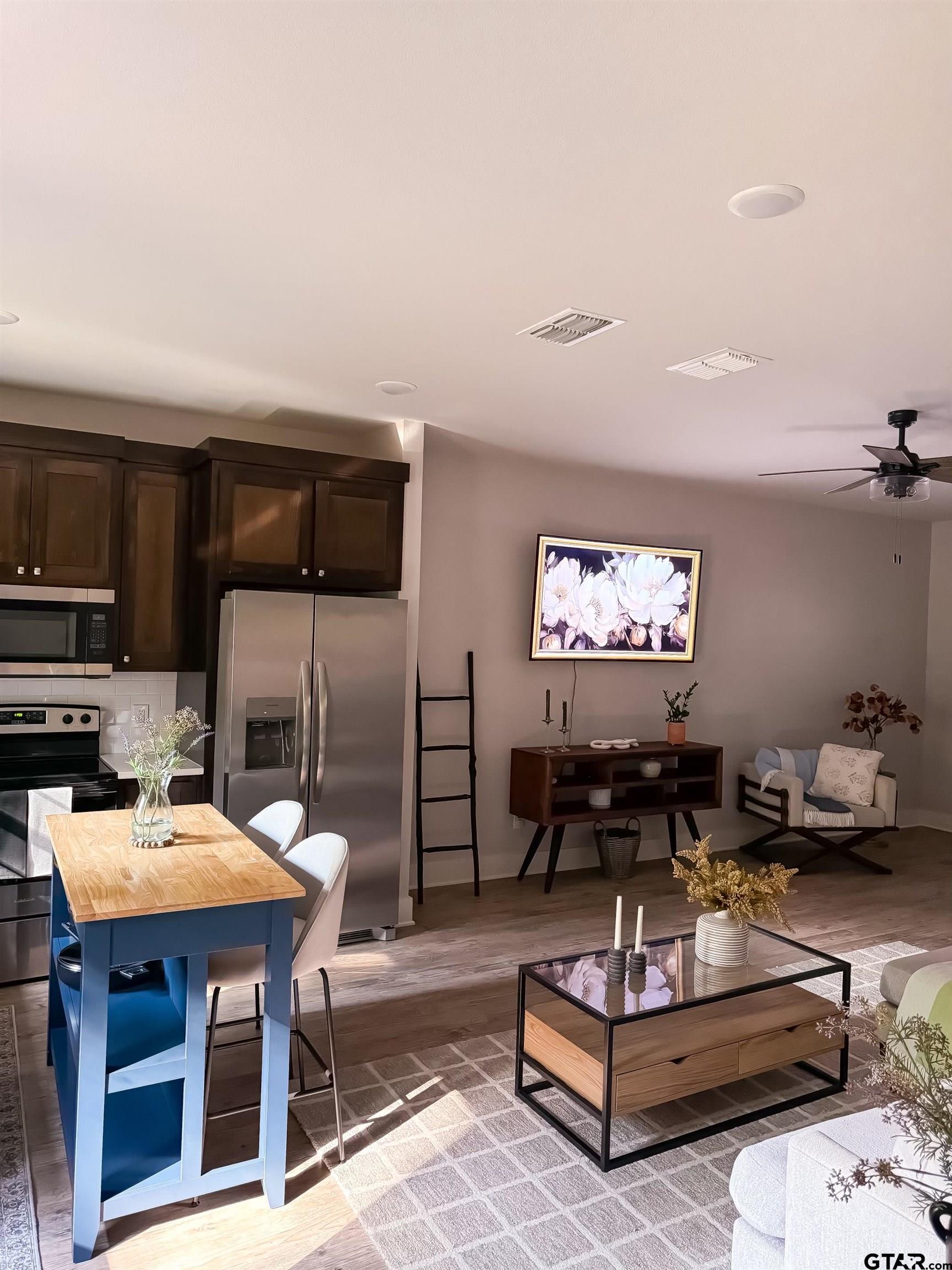 11722 Fm 16, Unit A Lindale, TX 75771 - Photo 10 of 17 a living room with furniture a flat screen tv and kitchen view