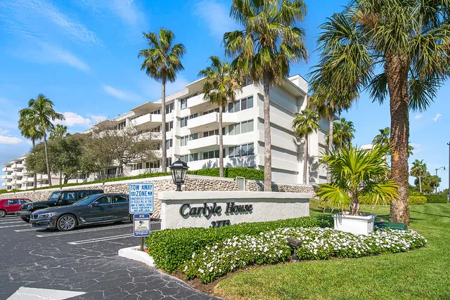 a view of a terrace with a table and chairs under an umbrella