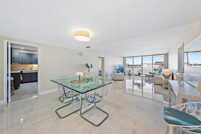 a living room with furniture and a view of kitchen