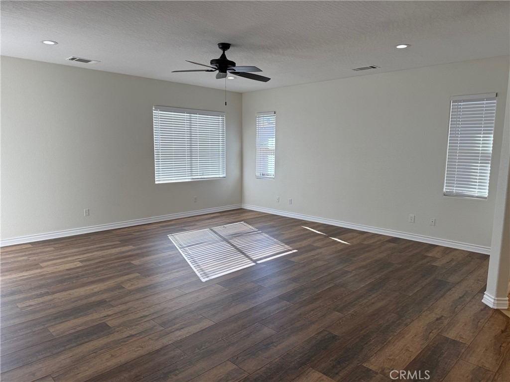 18453 Ranchero Road Hesperia, CA 92345 - Photo 7 of 17 a view of empty room with wooden floor and fan
