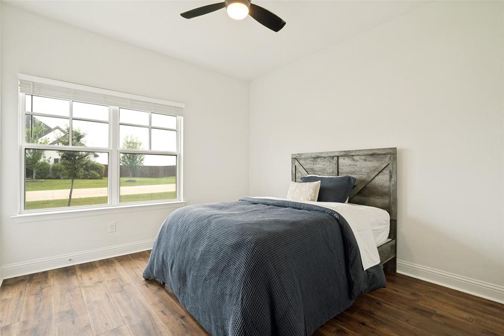 9424 Wildcat Ridge Godley, TX 76044 - Photo 16 of 25 a bed sitting in a bedroom next to a window