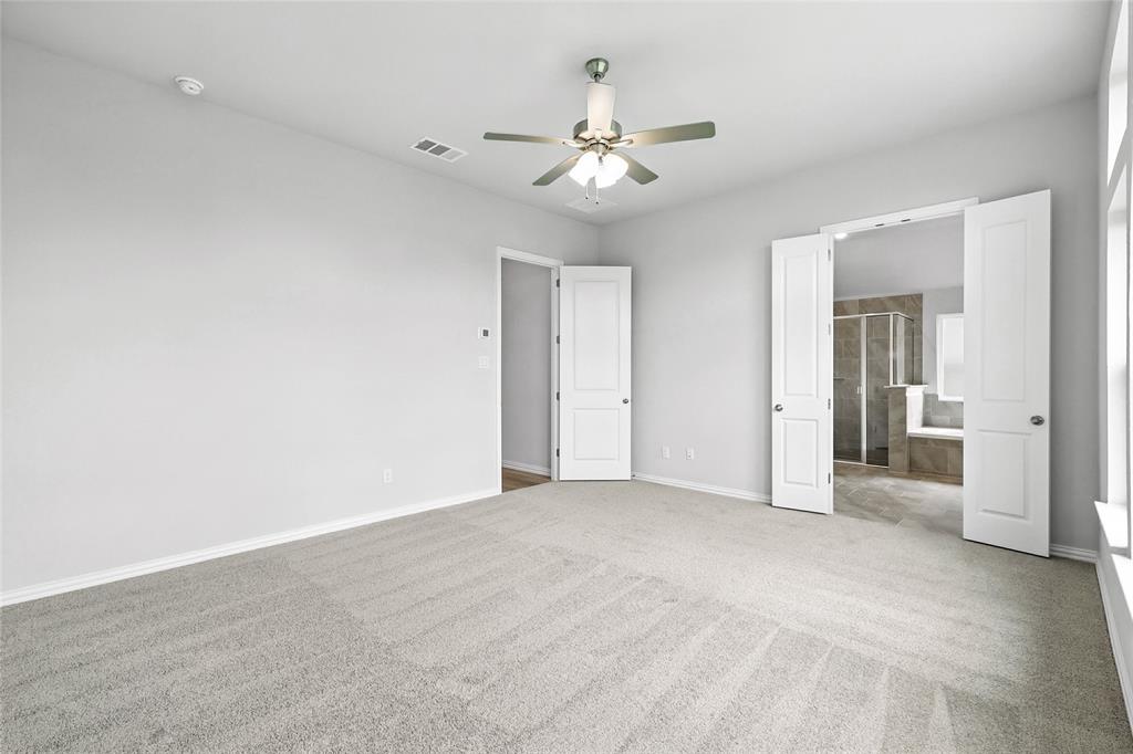 530 Red Barn Drive Van Alstyne, TX 75495 - Photo 14 of 40 Unfurnished bedroom featuring carpet flooring, connected bathroom, and ceiling fan