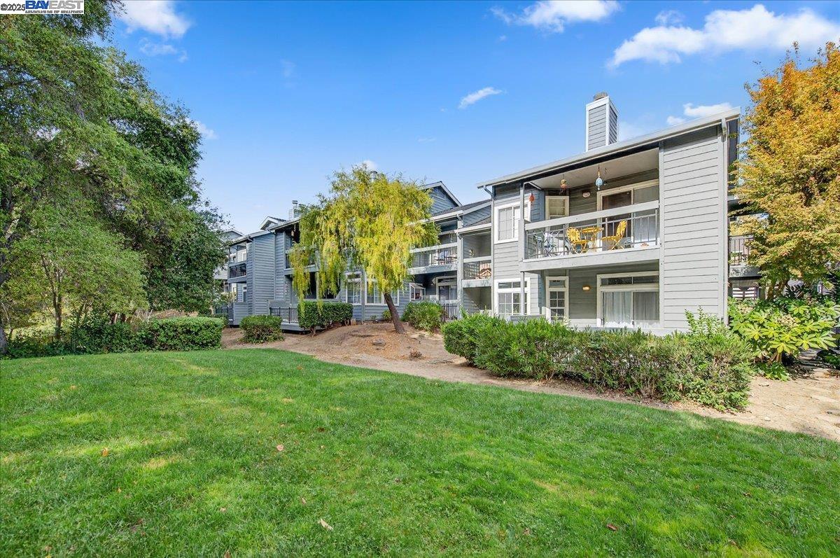 7875 Canyon Meadows Circle, Unit C Pleasanton, CA 94588 - Photo 1 of 32 a front view of a house with a yard