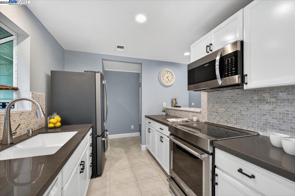 7875 Canyon Meadows Circle, Unit C Pleasanton, CA 94588 - Photo 12 of 32 a kitchen with stainless steel appliances a stove microwave and sink
