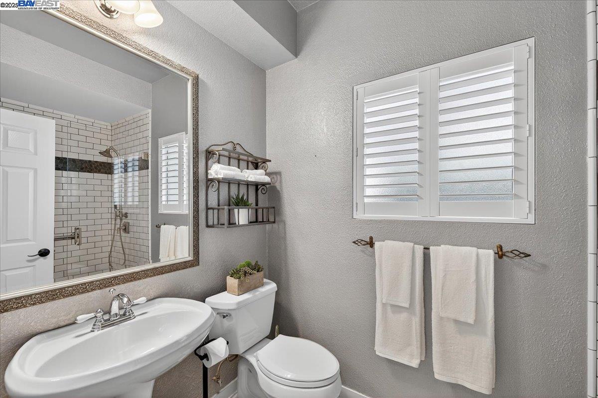 7875 Canyon Meadows Circle, Unit C Pleasanton, CA 94588 - Photo 17 of 32 a bathroom with a sink toilet a mirror and shower