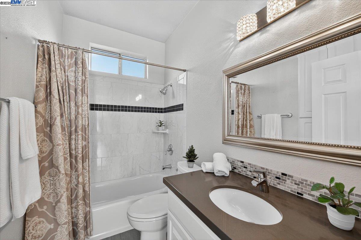 7875 Canyon Meadows Circle, Unit C Pleasanton, CA 94588 - Photo 22 of 32 a bathroom with a sink toilet a mirror and shower