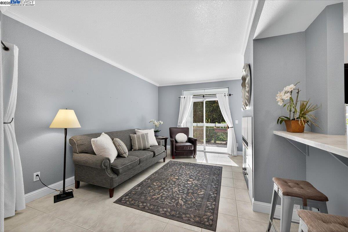 7875 Canyon Meadows Circle, Unit C Pleasanton, CA 94588 - Photo 7 of 32 a living room with furniture and wooden floor