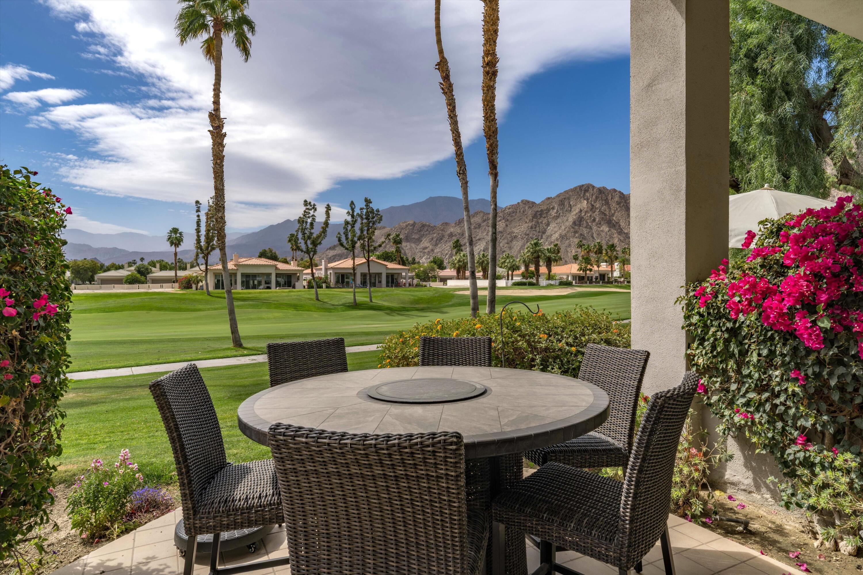 54053 Oak-Hill La Quinta, CA 92253 - Photo 1 of 36 a view of a patio with a table chairs and a garden