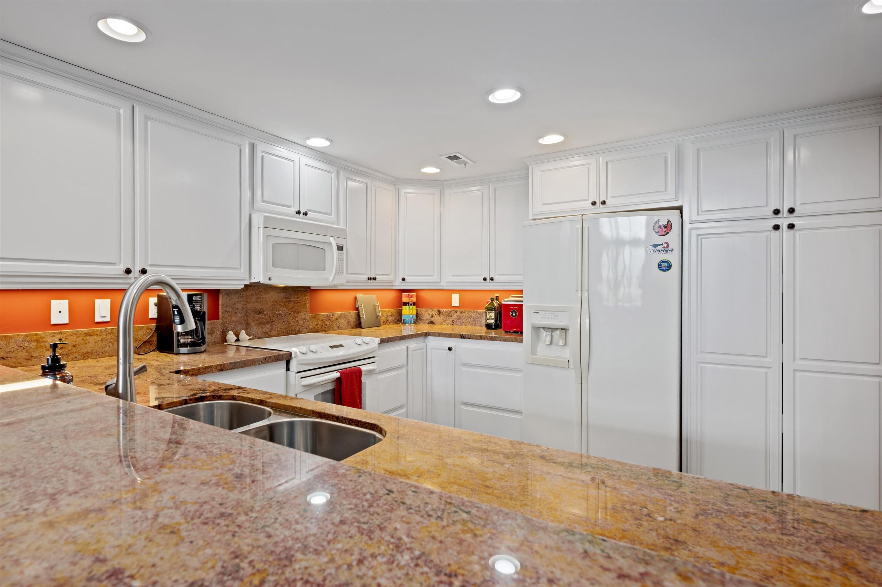 54053 Oak-Hill La Quinta, CA 92253 - Photo 11 of 36 a kitchen with stainless steel appliances a refrigerator and a stove