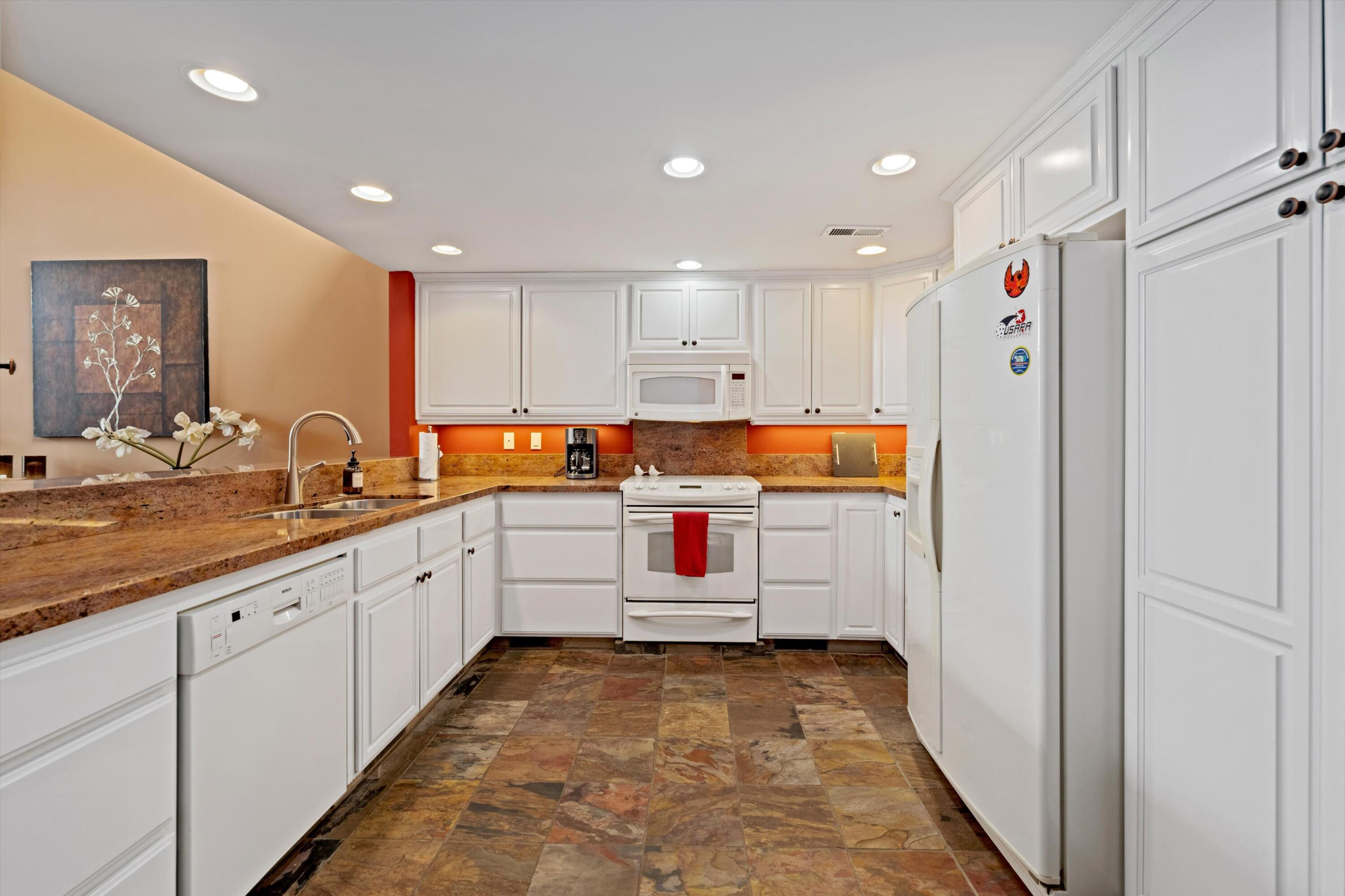 54053 Oak-Hill La Quinta, CA 92253 - Photo 12 of 36 a room with lot of cabinets and wooden floors