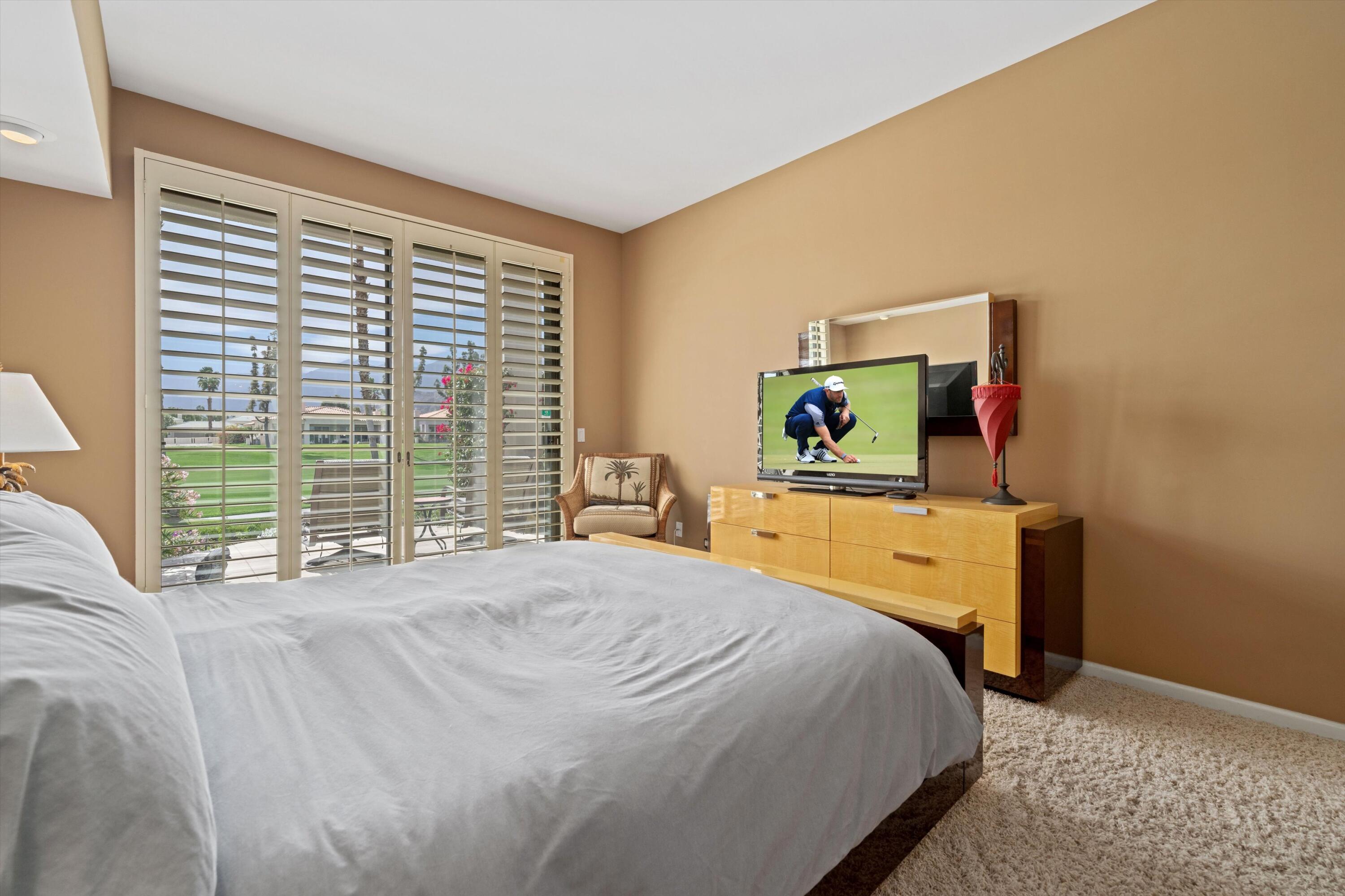 54053 Oak-Hill La Quinta, CA 92253 - Photo 15 of 36 a bedroom with a bed and a dresser next to a window