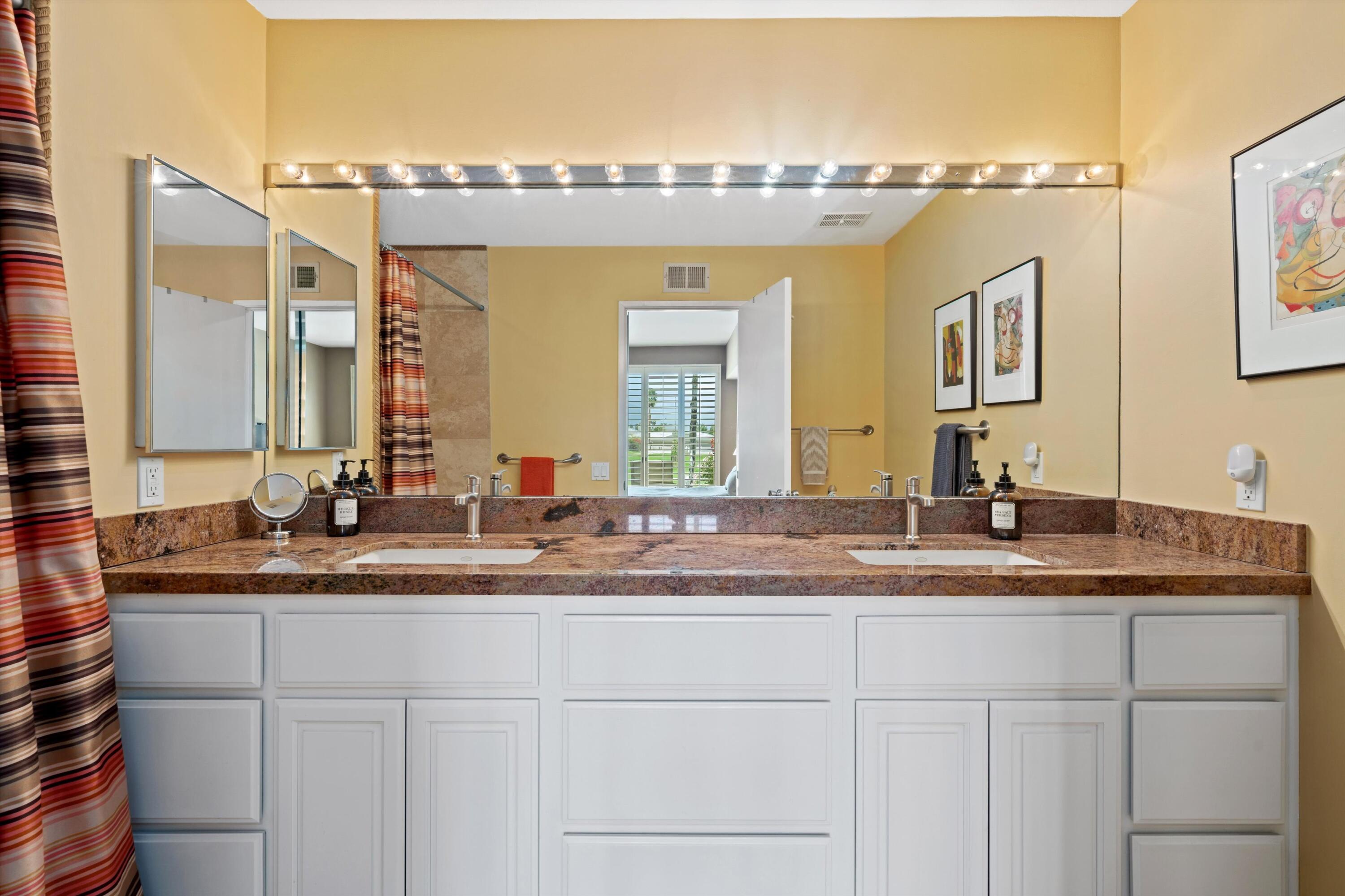 54053 Oak-Hill La Quinta, CA 92253 - Photo 17 of 36 a bathroom with a sink and a mirror