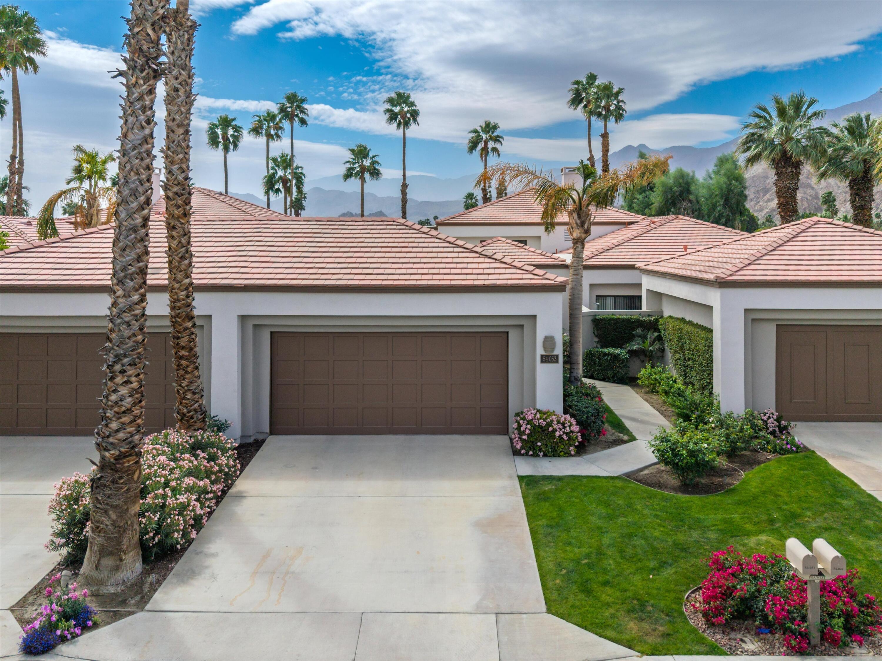 54053 Oak-Hill La Quinta, CA 92253 - Photo 2 of 36 a front view of a house with a garden