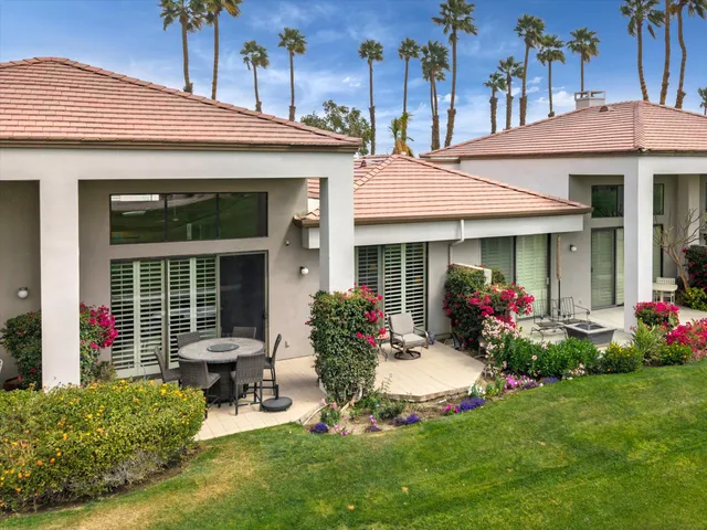 a view of a house with outdoor seating