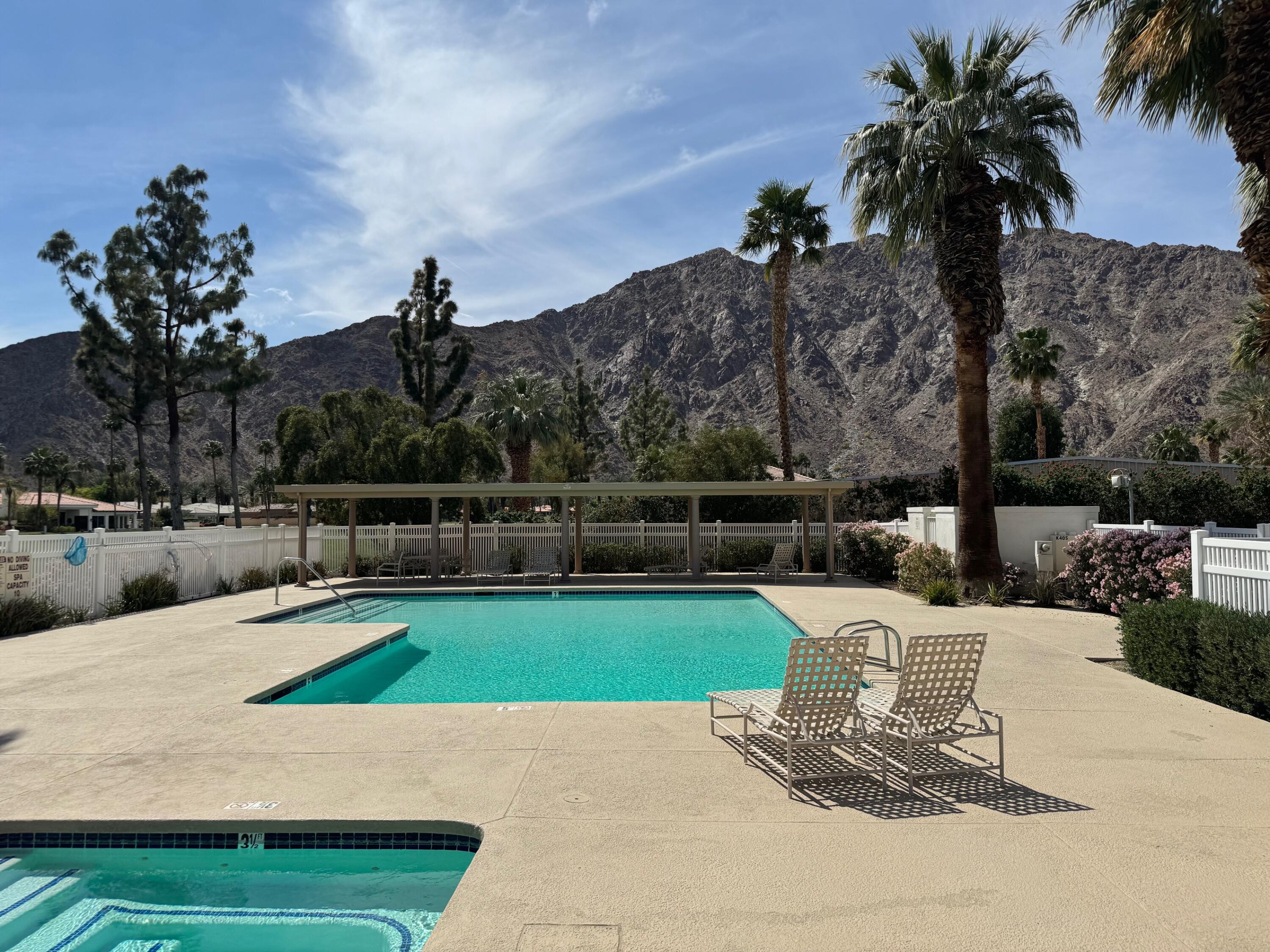 54053 Oak-Hill La Quinta, CA 92253 - Photo 34 of 36 a view of a swimming pool with a patio and a garden
