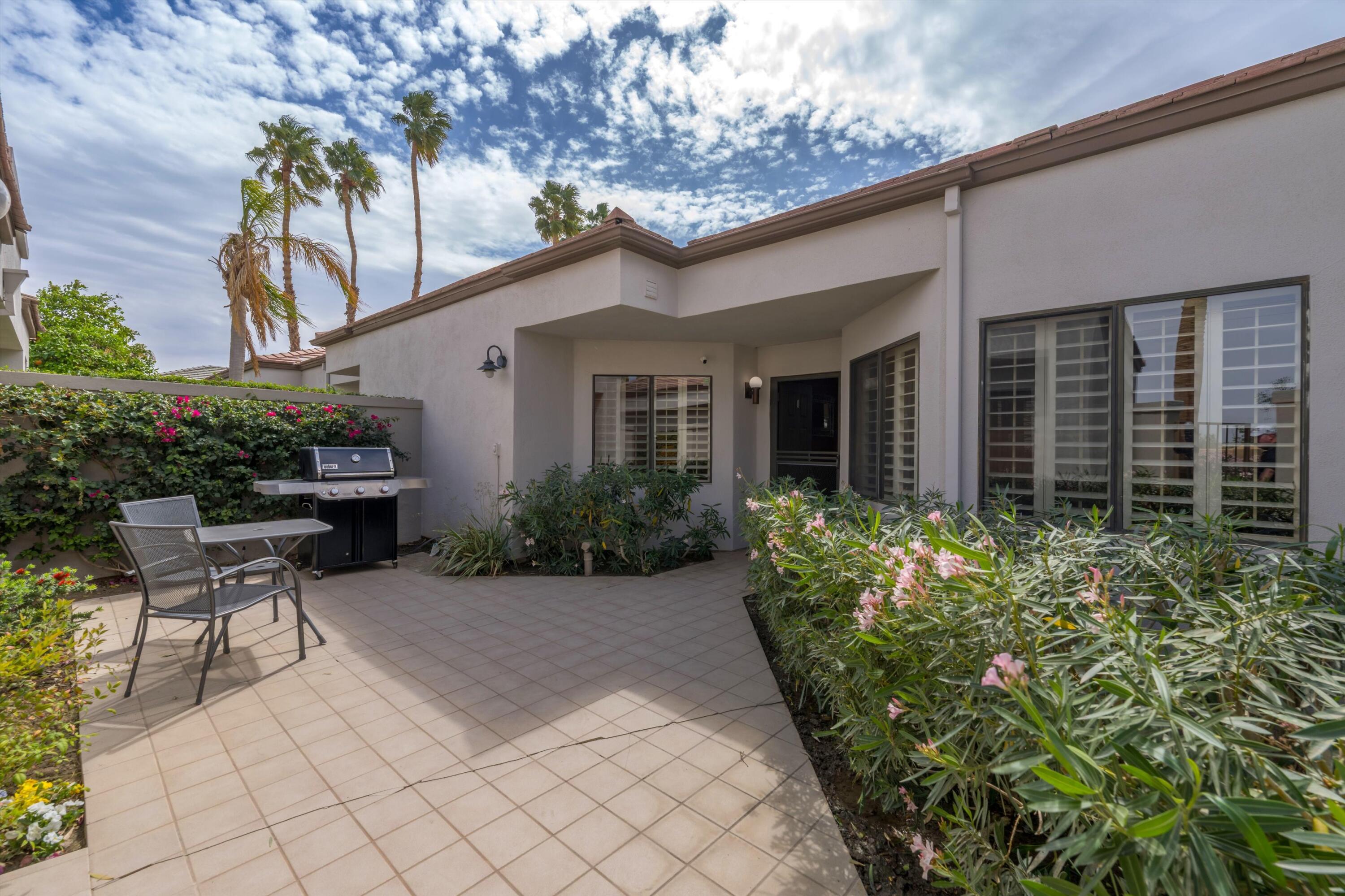 54053 Oak-Hill La Quinta, CA 92253 - Photo 4 of 36 a backyard of a house with plants and outdoor seating