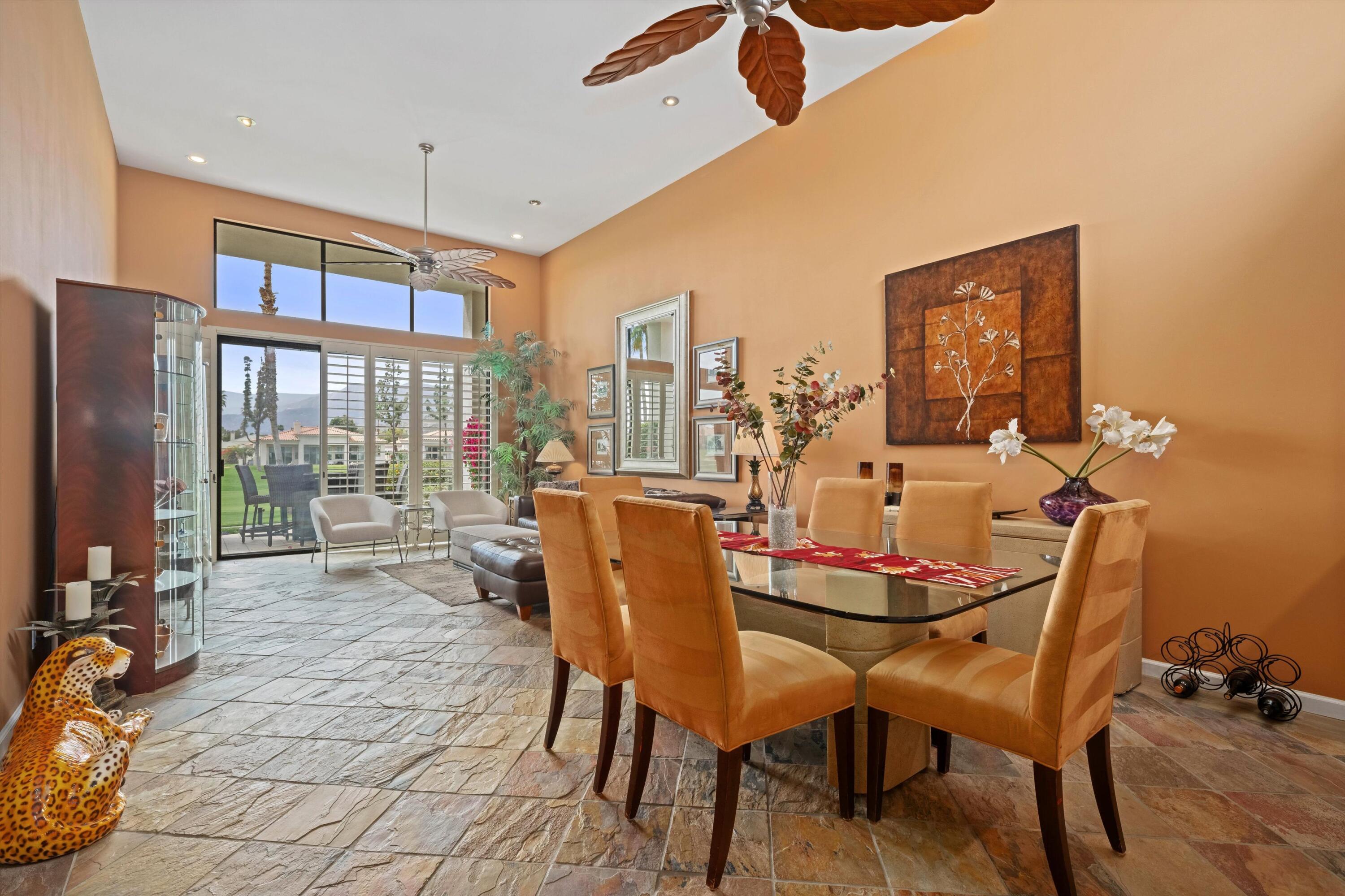 54053 Oak-Hill La Quinta, CA 92253 - Photo 6 of 36 a dining room with furniture a chandelier and a rug