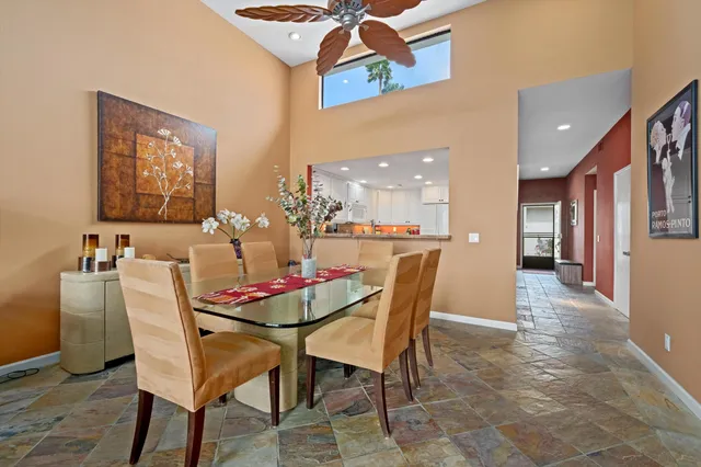 a dining room with furniture and wooden floor