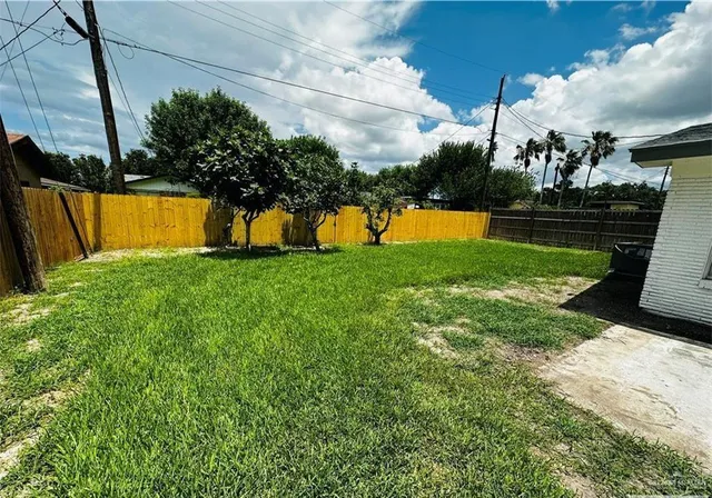 a view of yard with swimming pool and trees