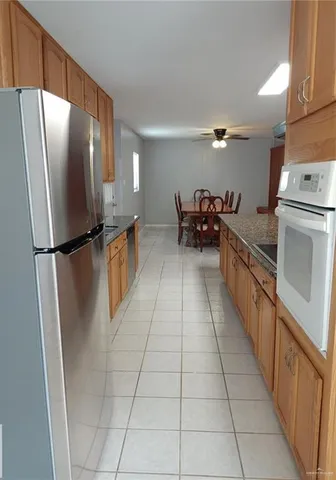 a kitchen with stainless steel appliances a refrigerator and a stove