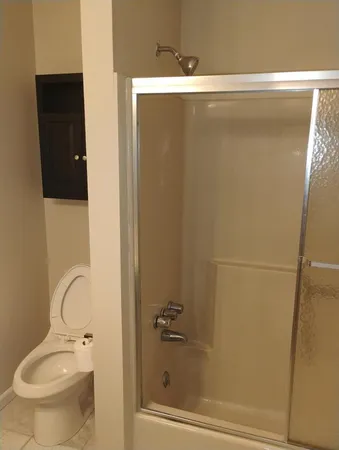 a bathroom with a shower and a toilet