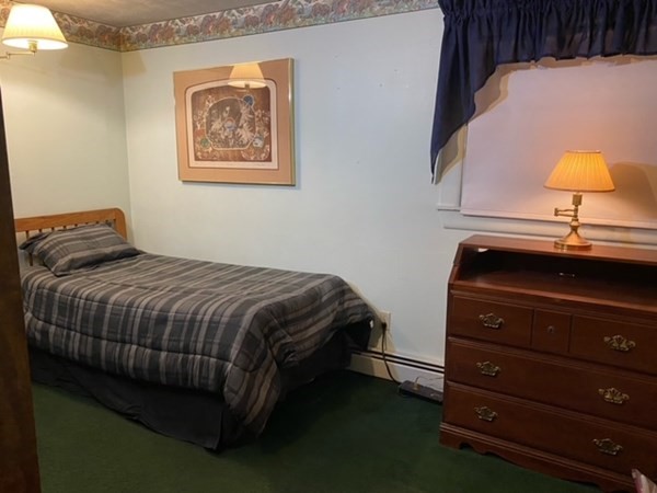 12 Wedgemere Road Beverly, MA 01915 - Photo 8 of 10 a bedroom with a bed and a lamp on dresser