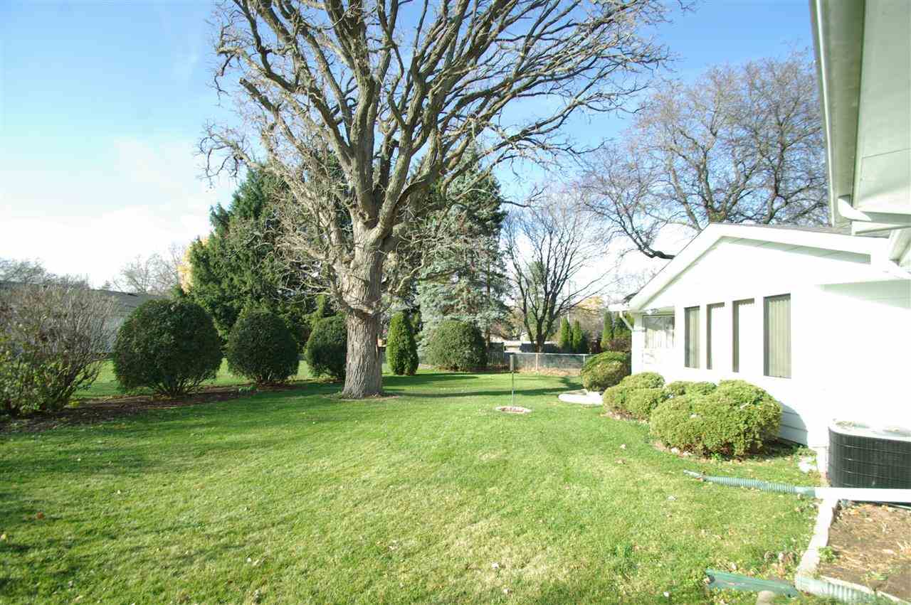 5460 Brookview Road Rockford, IL 61107 - Photo 20 of 20 a view of a house with a big yard and large trees