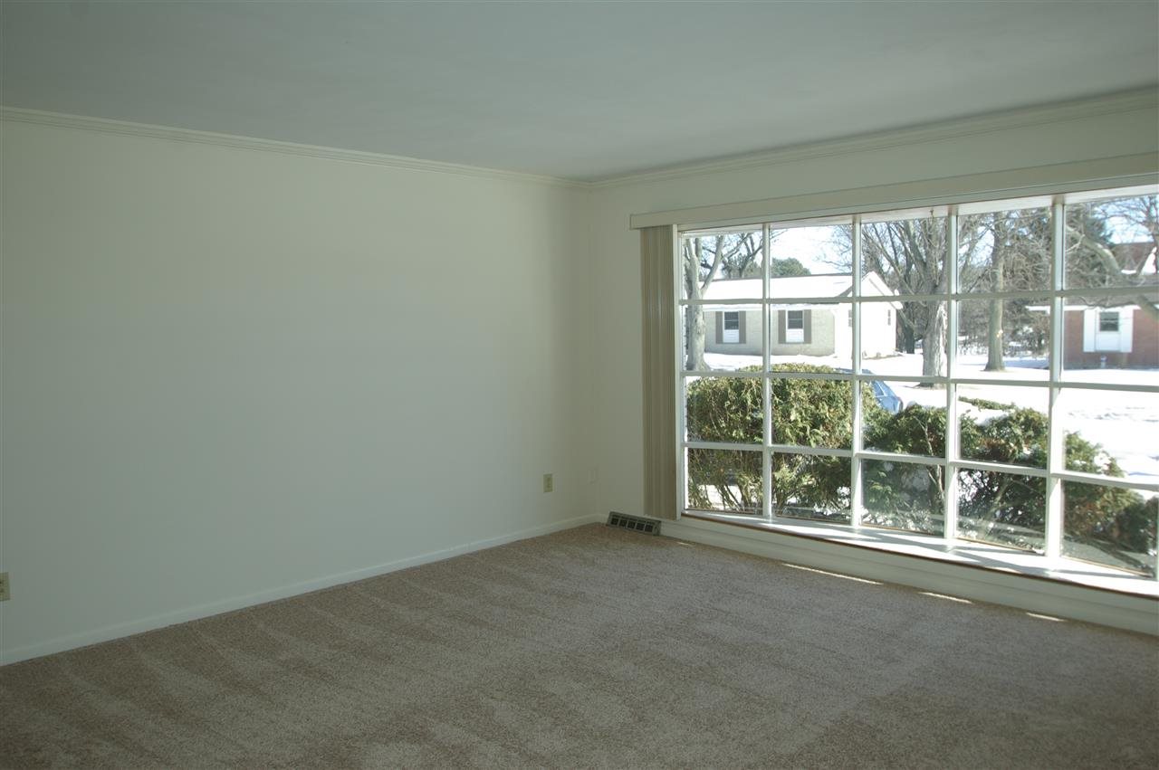 5460 Brookview Road Rockford, IL 61107 - Photo 2 of 20 an empty room with wooden floor and garden