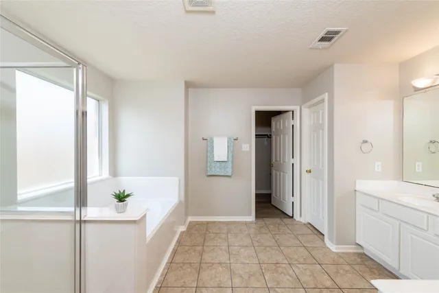 a bathroom with a tub and shower