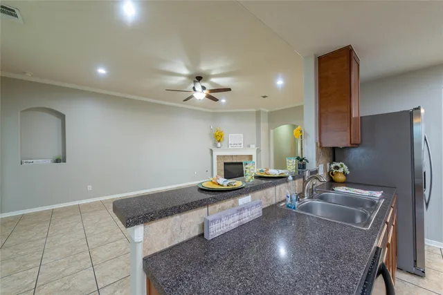 a kitchen with sink refrigerator and stove