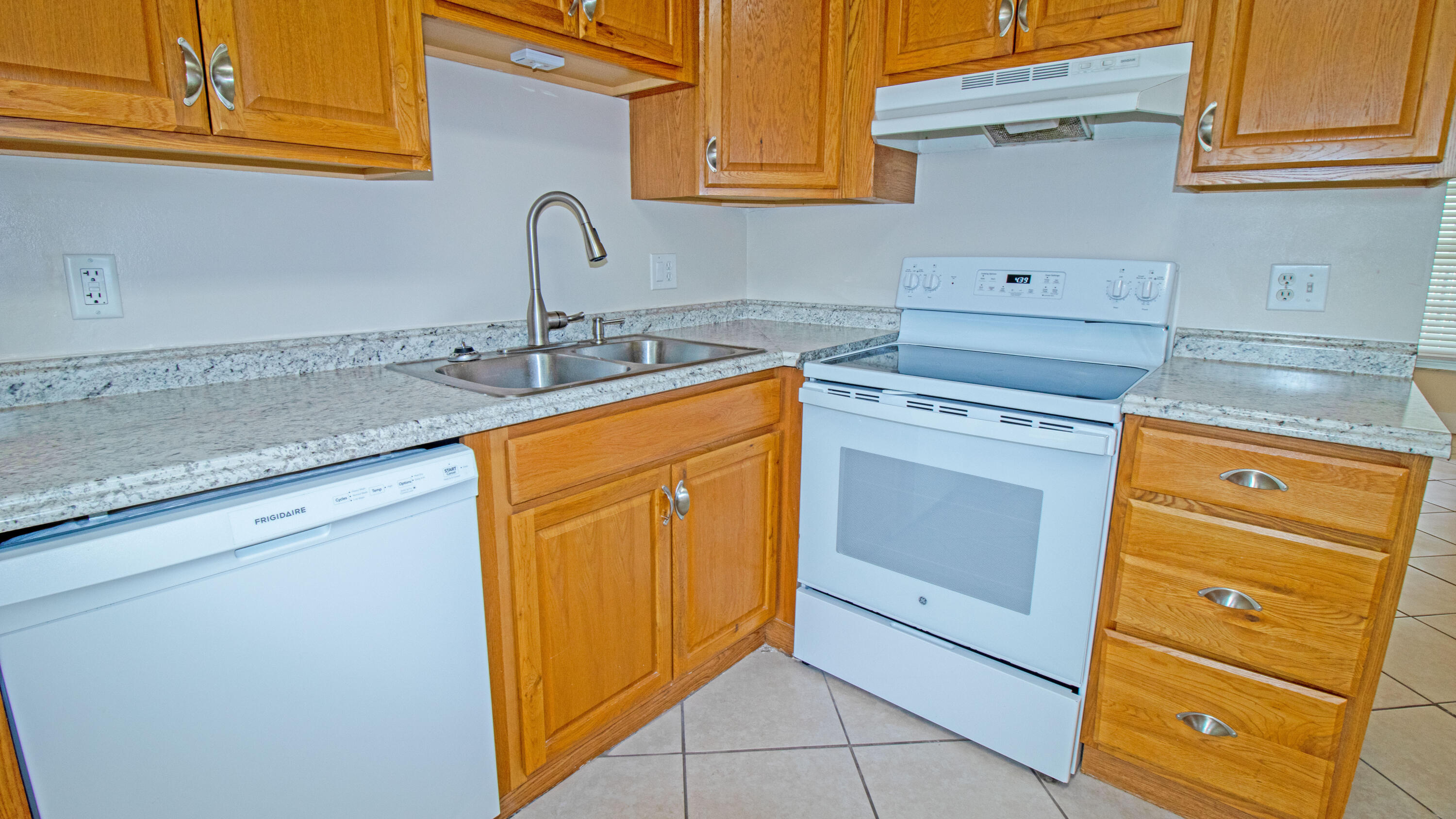 8757 Southeast Hobe Ridge Avenue Hobe Sound, FL 33455 - Photo 11 of 29 a kitchen with a sink stove and cabinets