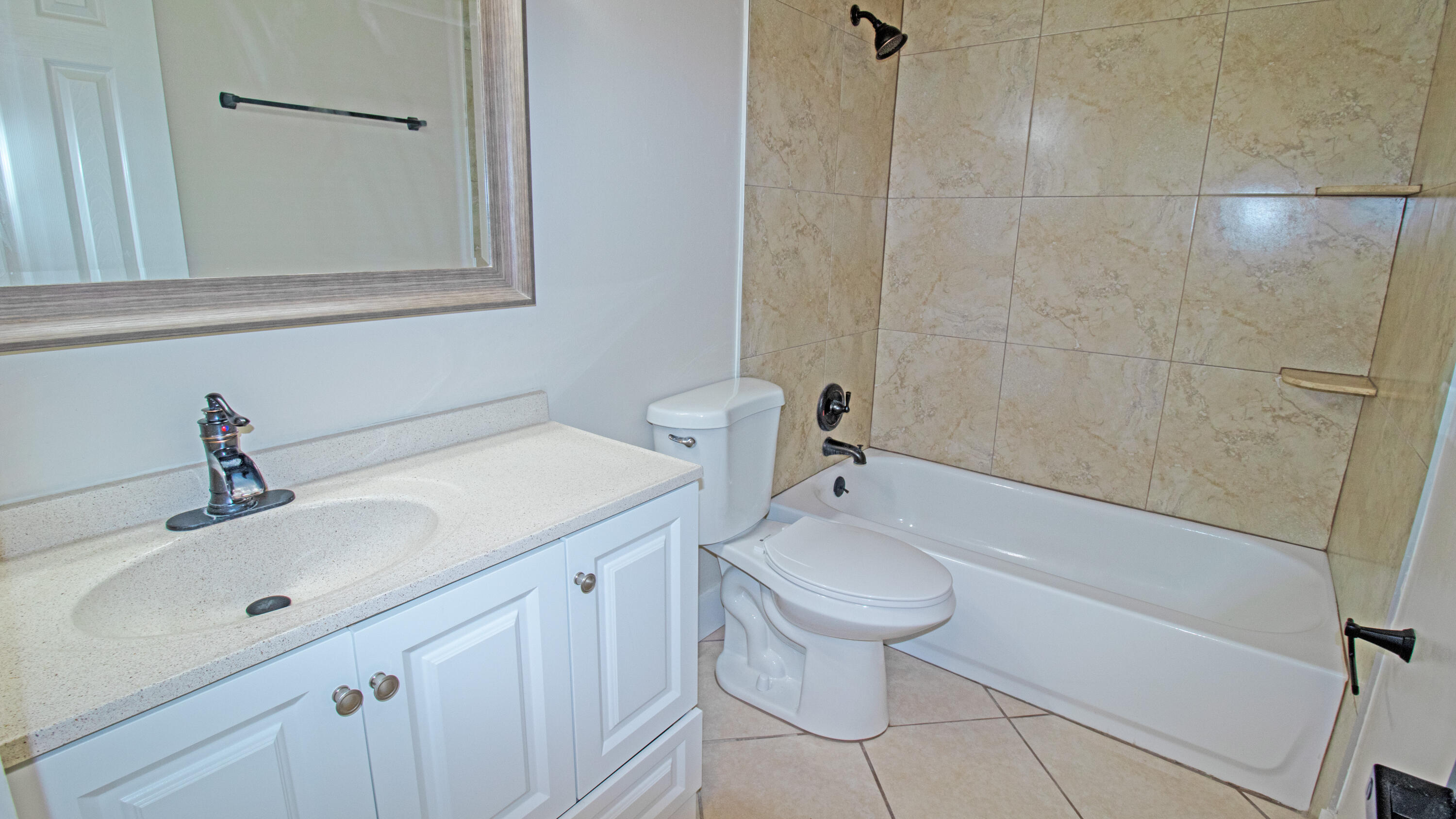 8757 Southeast Hobe Ridge Avenue Hobe Sound, FL 33455 - Photo 17 of 29 a bathroom with a sink a toilet and bathtub