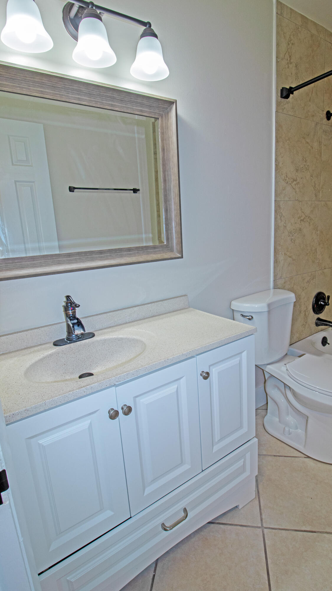 8757 Southeast Hobe Ridge Avenue Hobe Sound, FL 33455 - Photo 18 of 29 a bathroom with a sink and a toilet