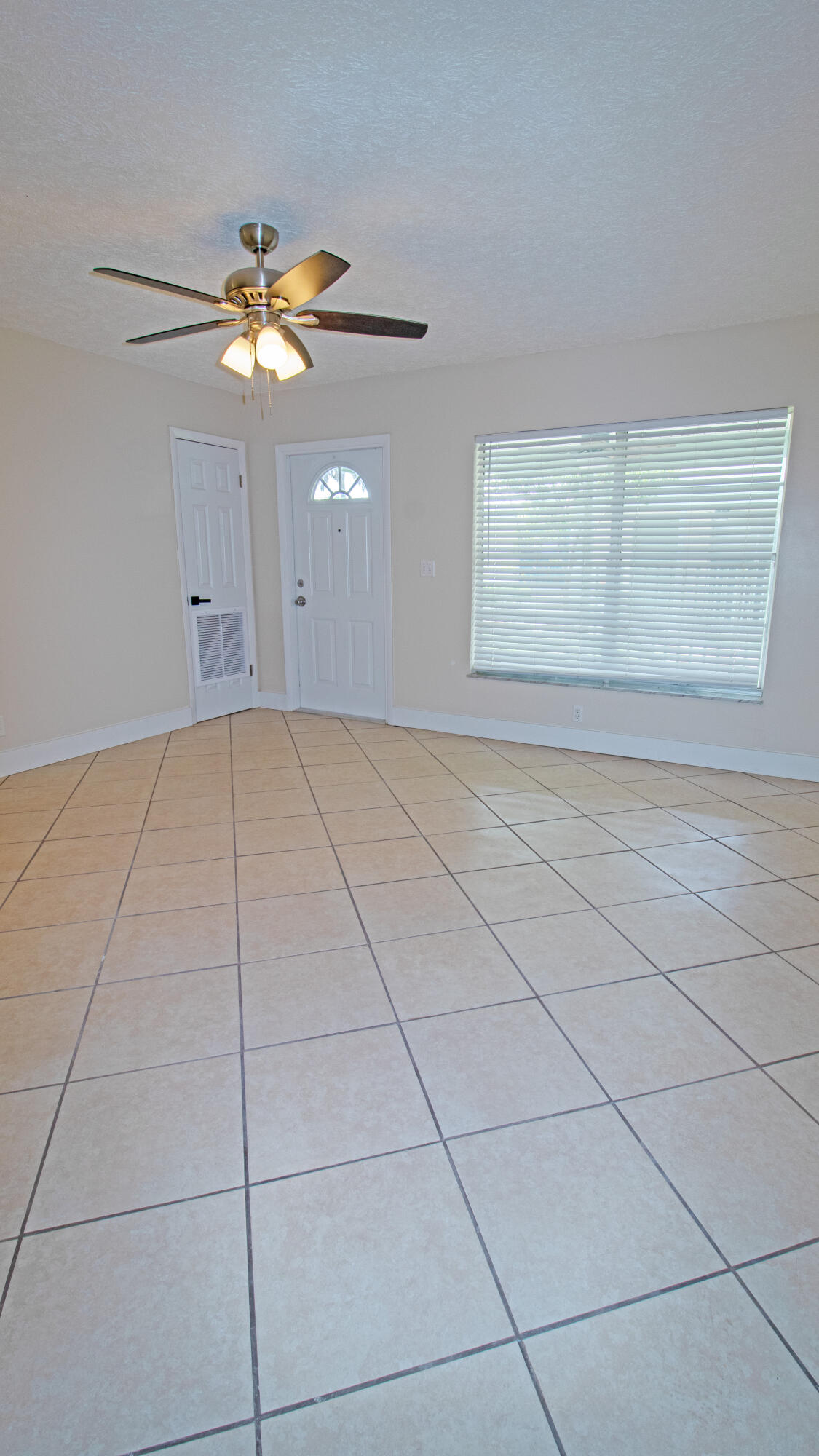 8757 Southeast Hobe Ridge Avenue Hobe Sound, FL 33455 - Photo 4 of 29 a view of an empty room with a window