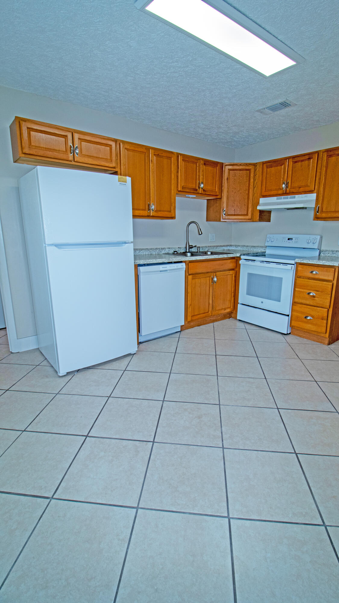 8757 Southeast Hobe Ridge Avenue Hobe Sound, FL 33455 - Photo 9 of 29 a kitchen with stainless steel appliances a counter top space and cabinets