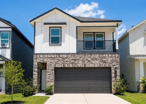 a front view of a house with garage