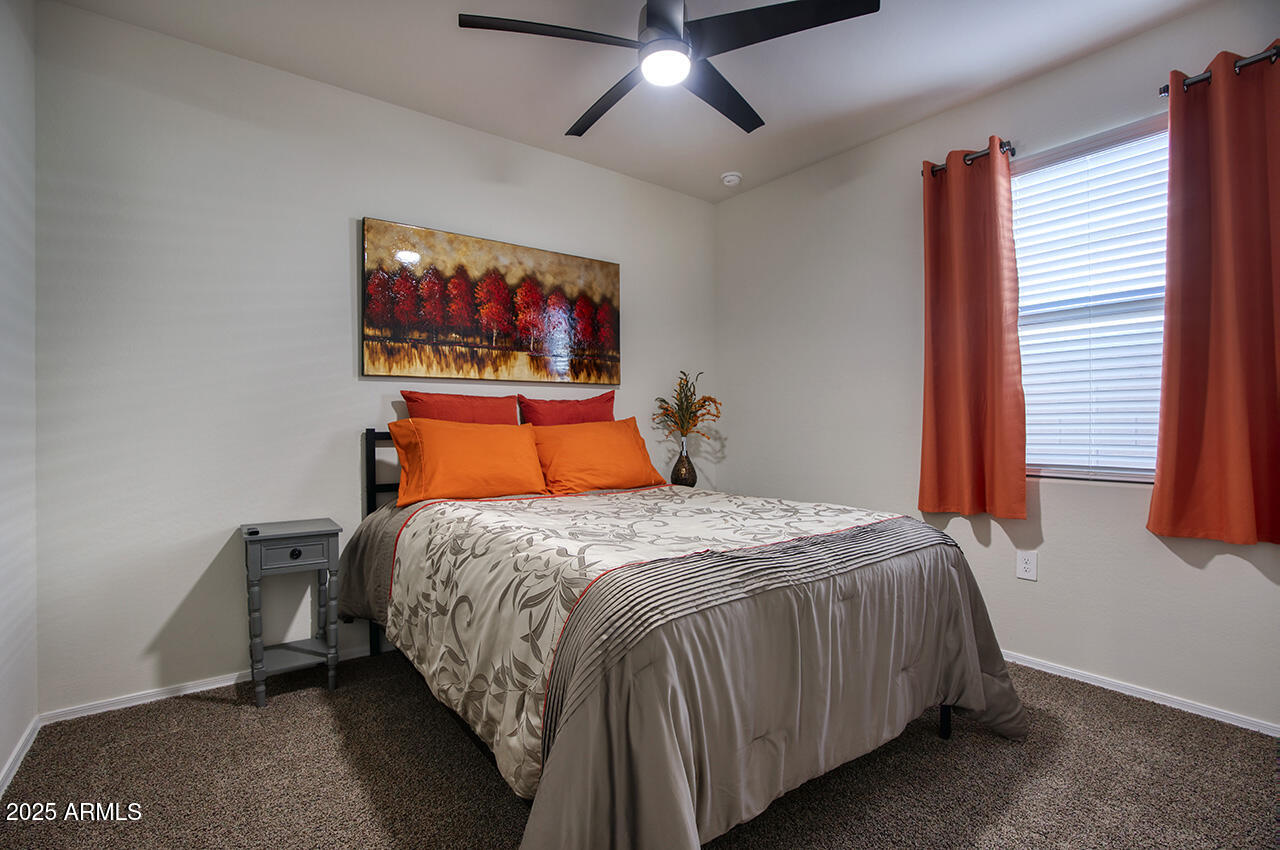 5236 East Emery Road San Tan Valley, AZ 85143 - Photo 11 of 24 a bed sitting in a bedroom next to a window