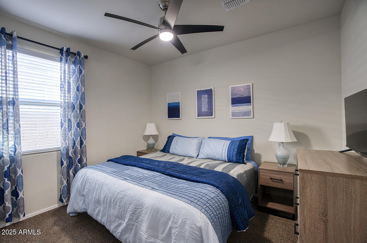 5236 East Emery Road San Tan Valley, AZ 85143 - Photo 12 of 24 a bedroom with a bed and a flat screen tv