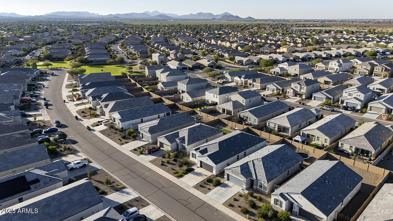 5236 East Emery Road San Tan Valley, AZ 85143 - Photo 19 of 24 an aerial view of a house with a swimming pool trees and buildings in the background