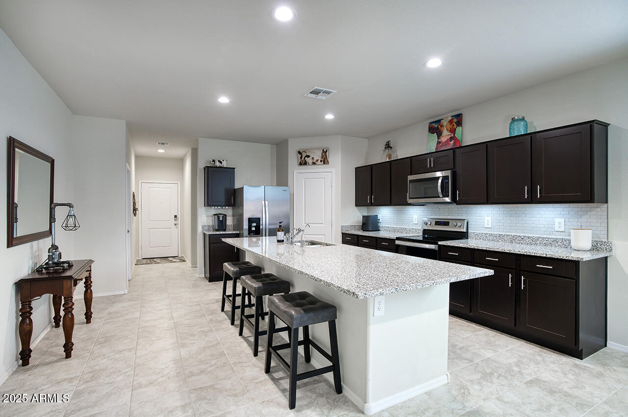 5236 East Emery Road San Tan Valley, AZ 85143 - Photo 4 of 24 a large kitchen with stainless steel appliances lots of counter space and breakfast area