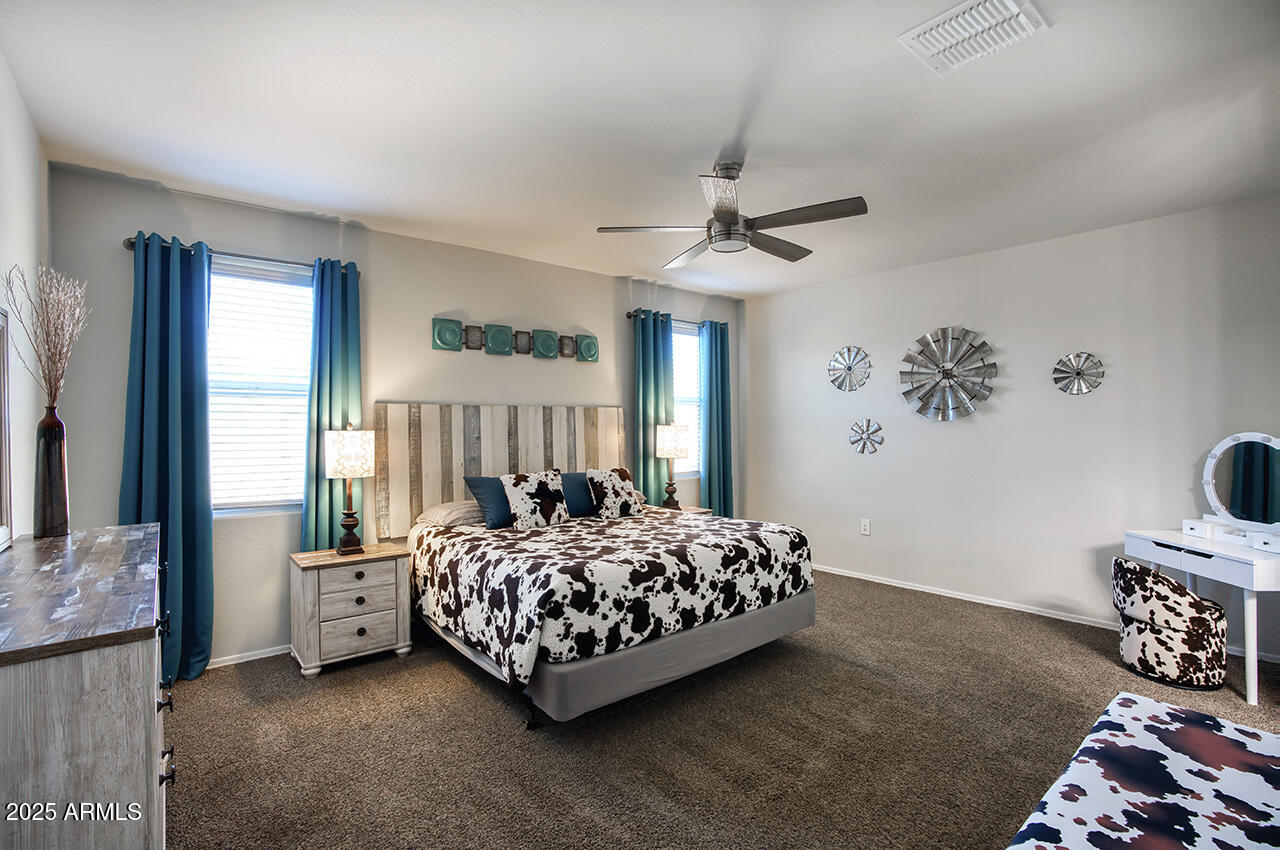 5236 East Emery Road San Tan Valley, AZ 85143 - Photo 5 of 24 a bedroom with a bed and a chandelier